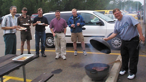 Jeff feeds the hungry crew: (from left) Paul LoBue, the UPS Guy, Don Larson, Steve Davies, Matt Harr, and Jeff Kranz