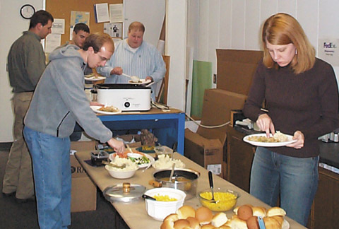 ason Laux, Cody Thiede, Mike Davis, Mike Woodard, and Mary Swab dig in at the annual Thanksgiving Turkey Dinner.